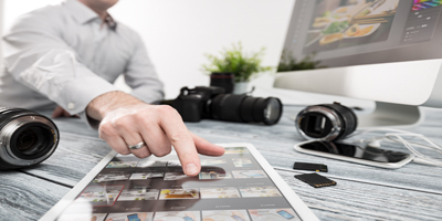 Photographer pointing at photos