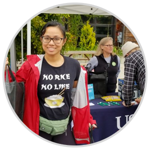 Smiling woman wearing a shirt that says 