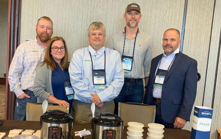 Quality-Symposium, HorizonAg-Team pose behind their table of samples & cookers