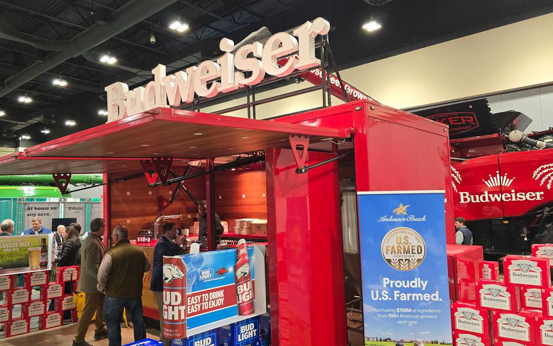 Budweiser-Bar, cases of beer surround bar car with customized combine in background