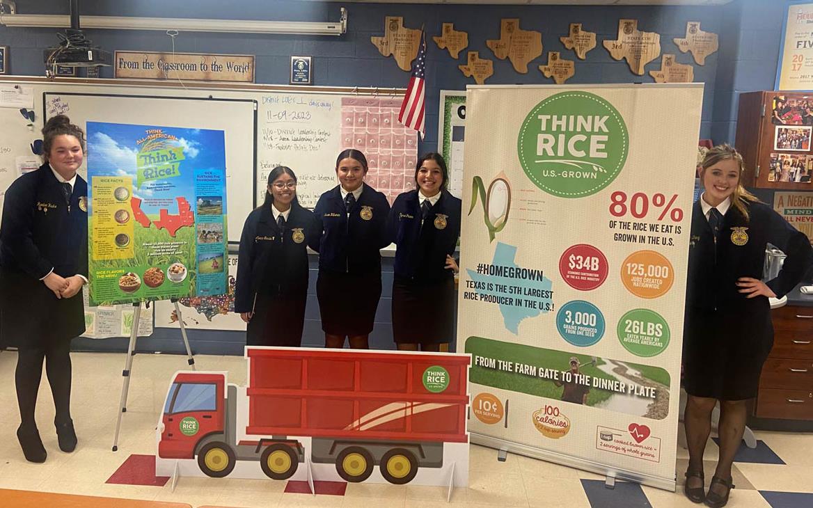 Honestly-TX-FFA-Promo: students show off promotional posters in classroom setting