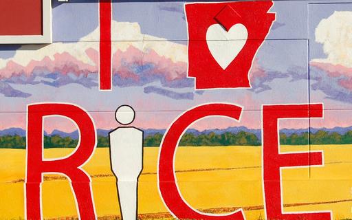 Colorful mural painted on wall with red text: I "heart" inside the outline of the state of Arkansas Rice