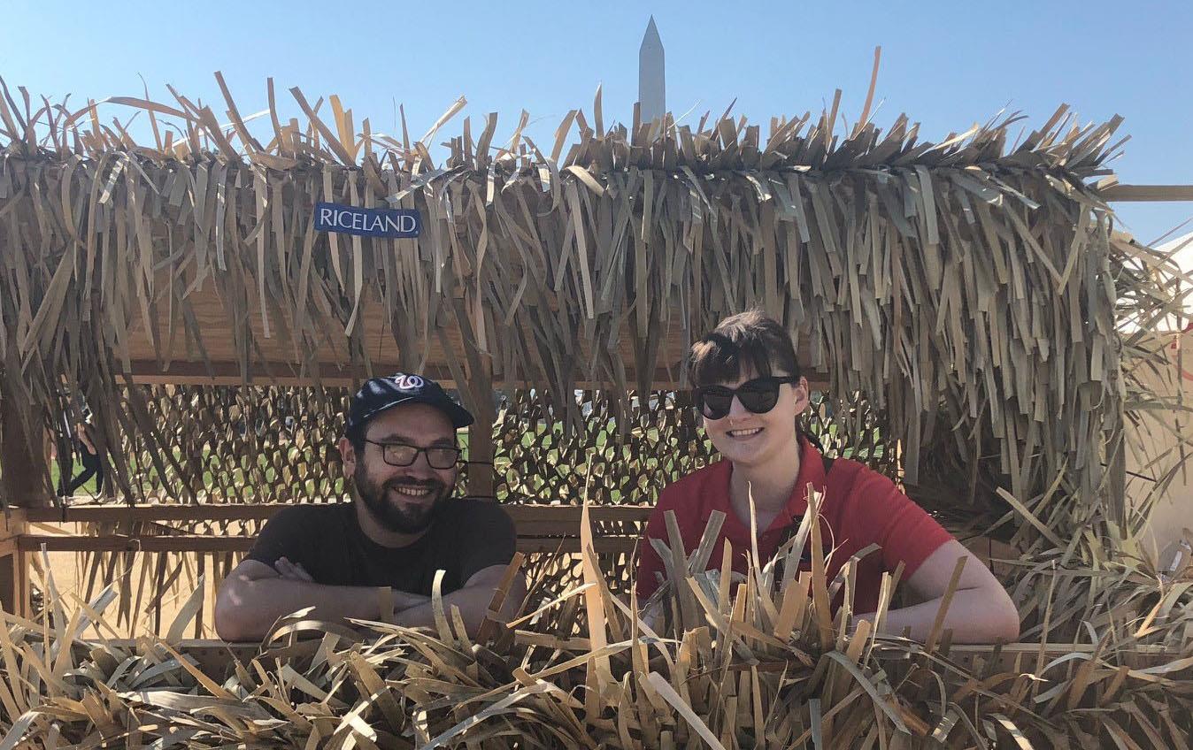 Riceland Duck Blind, two people amidst rice stalks that camouflage shooting gallery