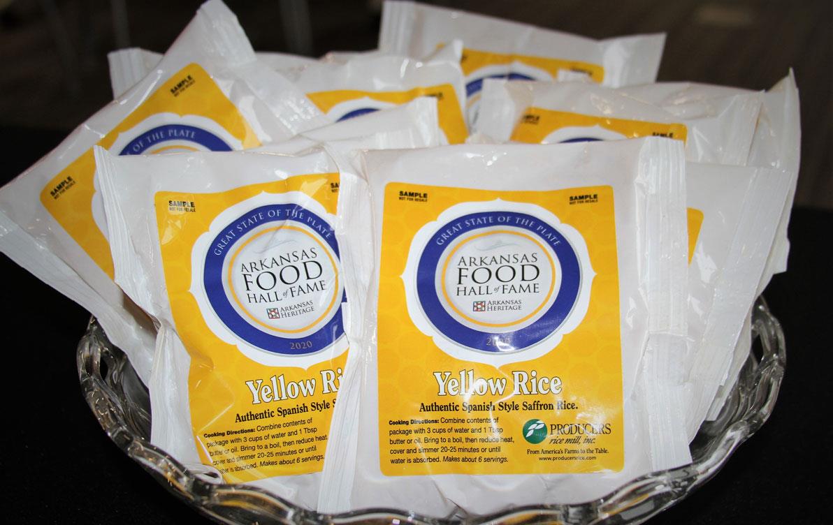 Bags of rice with colorful yellow & blue labels saying "Arkansas Food Hall of Fame"