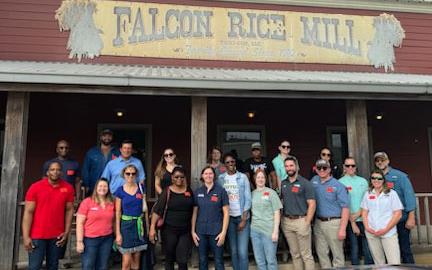 Staff-Retreat, group-shot standing in front of Falcon-Rice-Mill