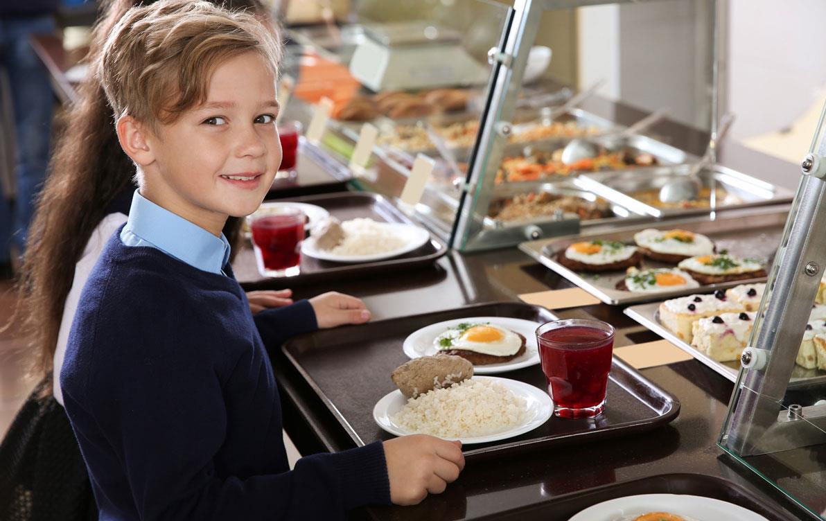 Young boy gets lunch in school cafeteria