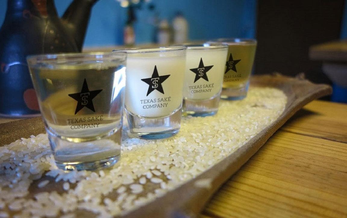 TX-Sake-Flight, glasses sitting in rice on wooden tray