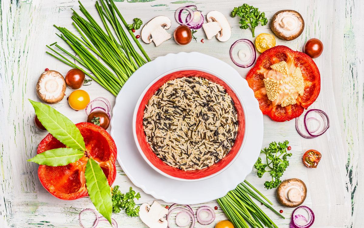 Healthy-Foodscape with colorful vegetables surrounding a bowl of mixed wild & brown rice