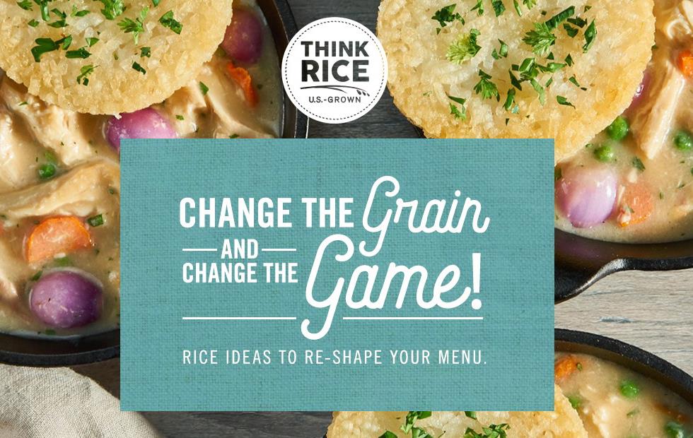 Background photo is three iron skillets filled with chicken, carrots, peas, and onions are topped with fried rice cakes, text block reads "Change the Grain and Change the Game!"