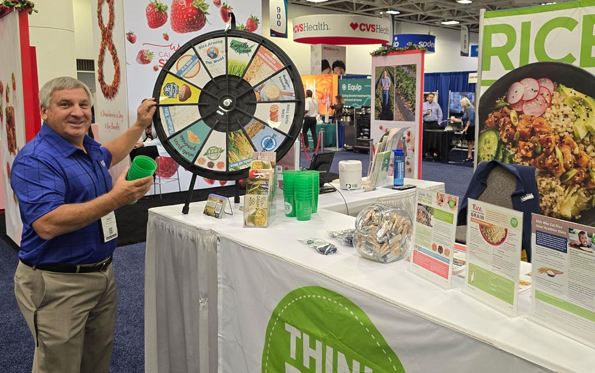 Arkansas rice farmer Robert-Petter plays the trivia wheel at-USAR-FNCE-Booth