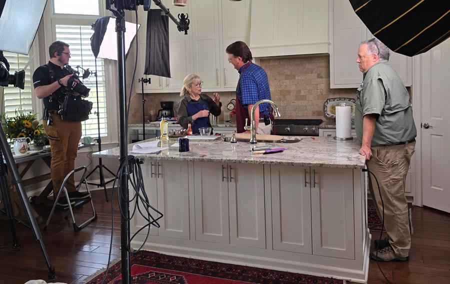 Camera crew sets up in Satterfield-Kitchen-with-kleig lights and video-equipment