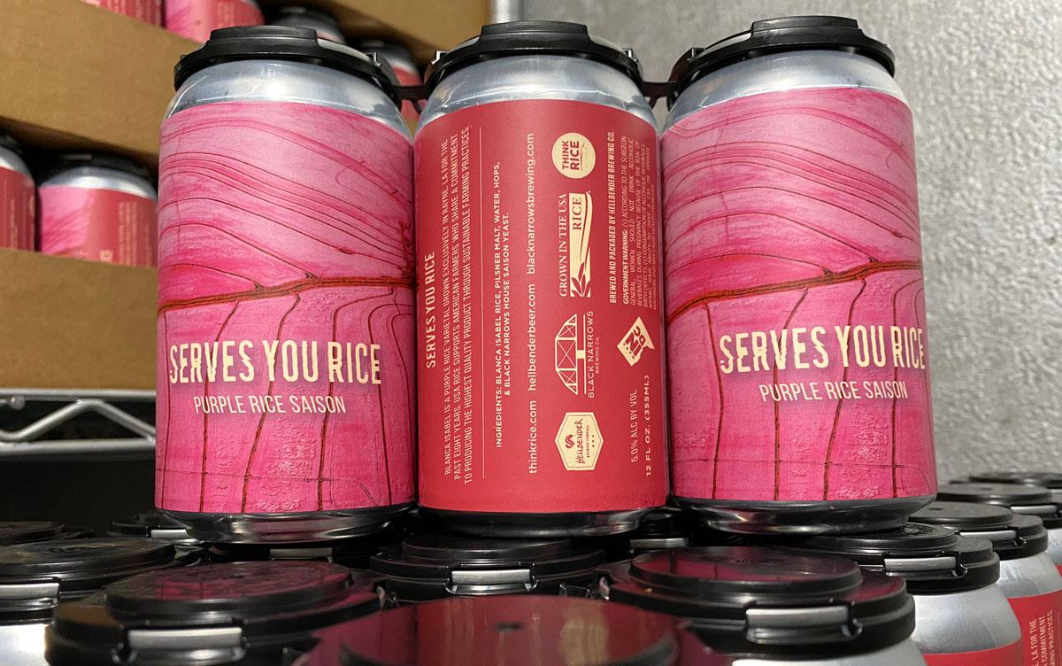 Serves You Rice beer cans with bright pink labels and US Grown logos