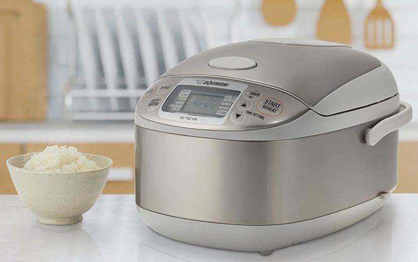 Zojirushi-rice-cooker and bowl of rice sitting on kitchen counter