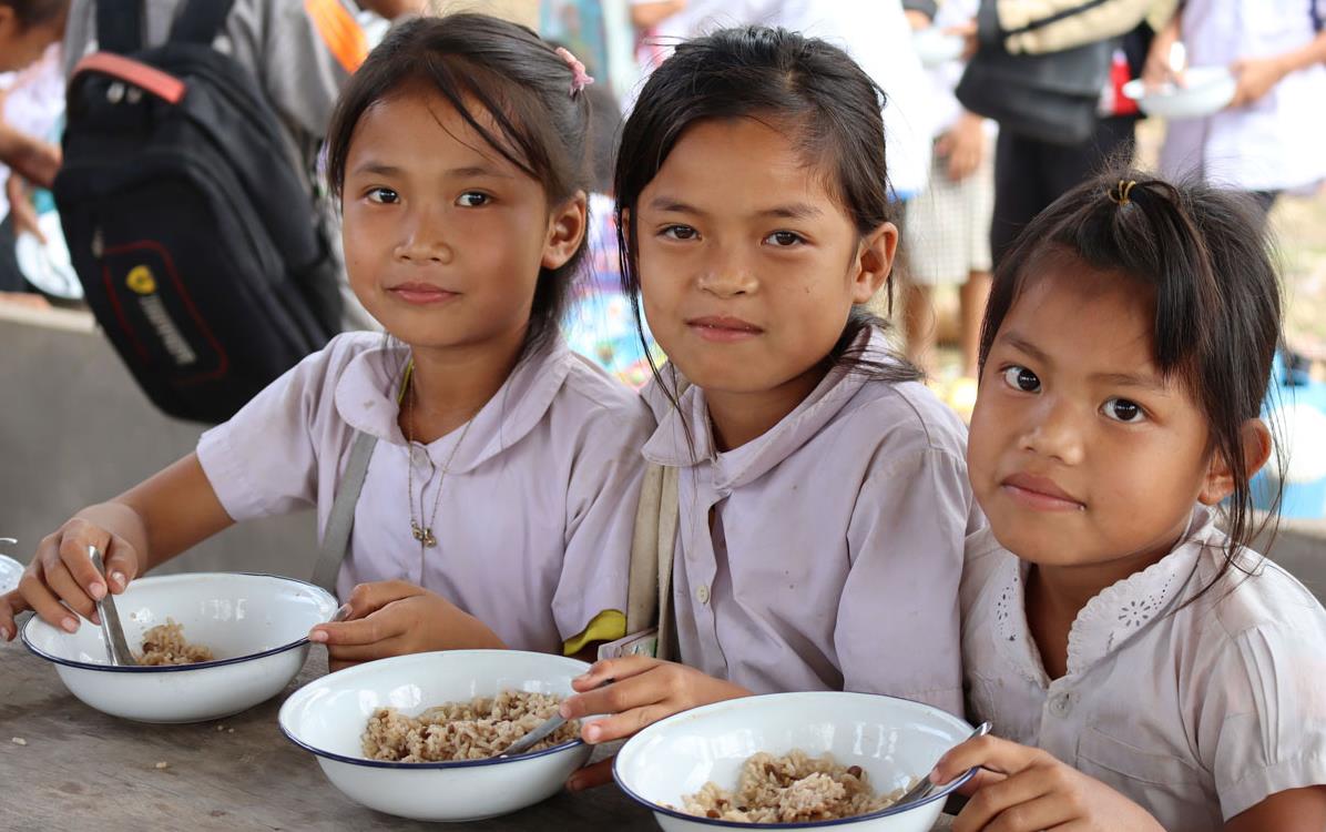 Trio-of-school-girls-eating-bowls-of-rice