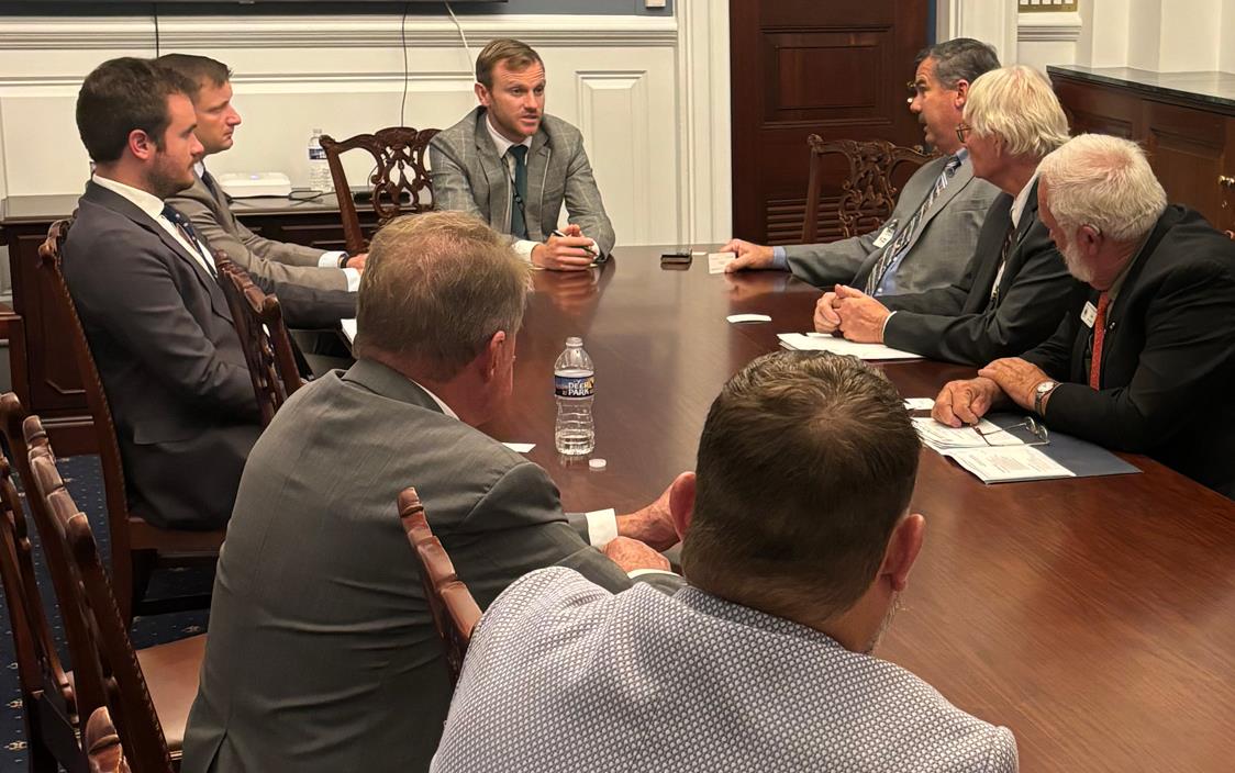 Commodity-Farmers go to Congress asking for meaningful-Farm-Bill, men in business suits sit at conference table