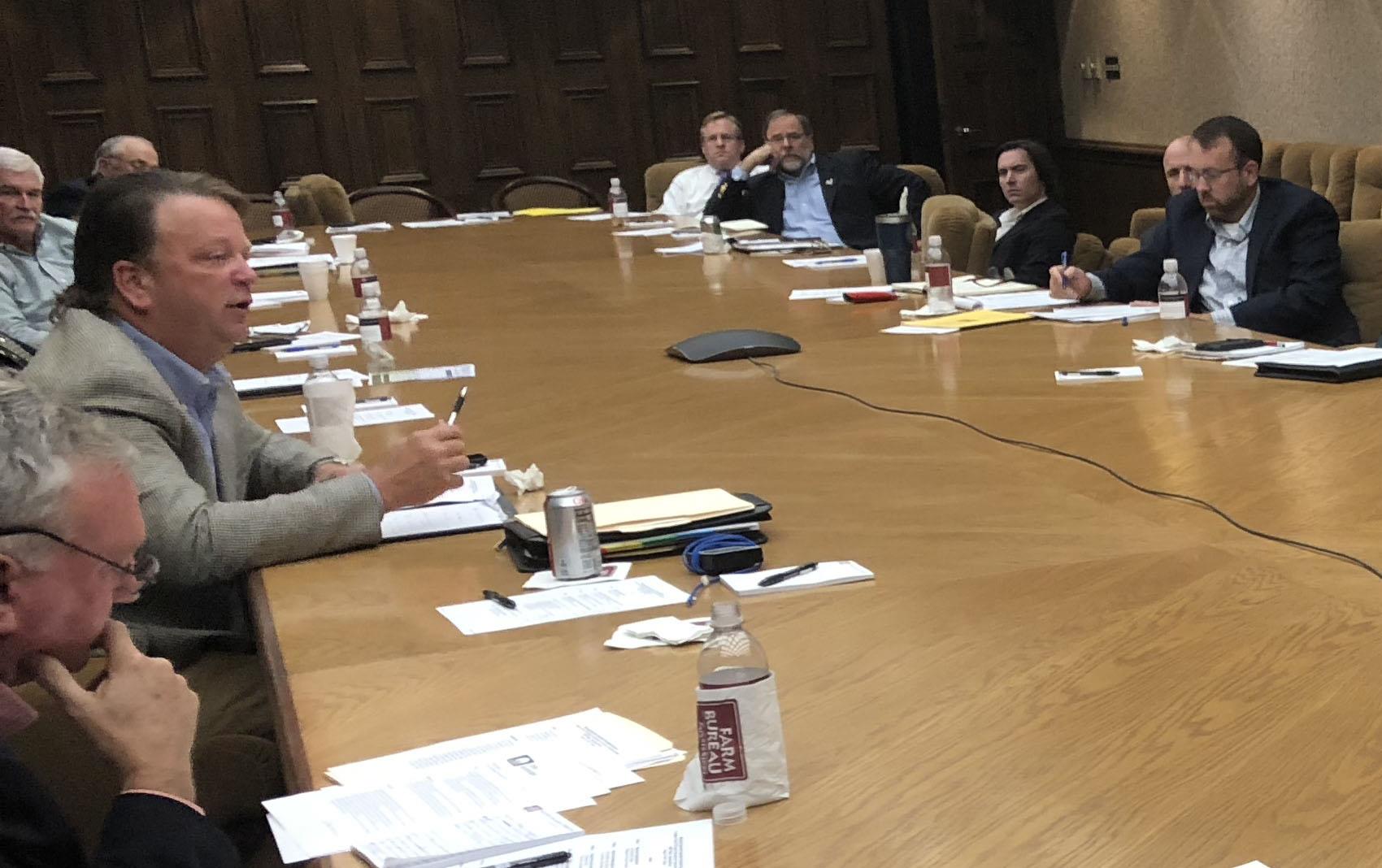 FDA round table discussion in Mississippi, group seated around large wooden table covered with papers