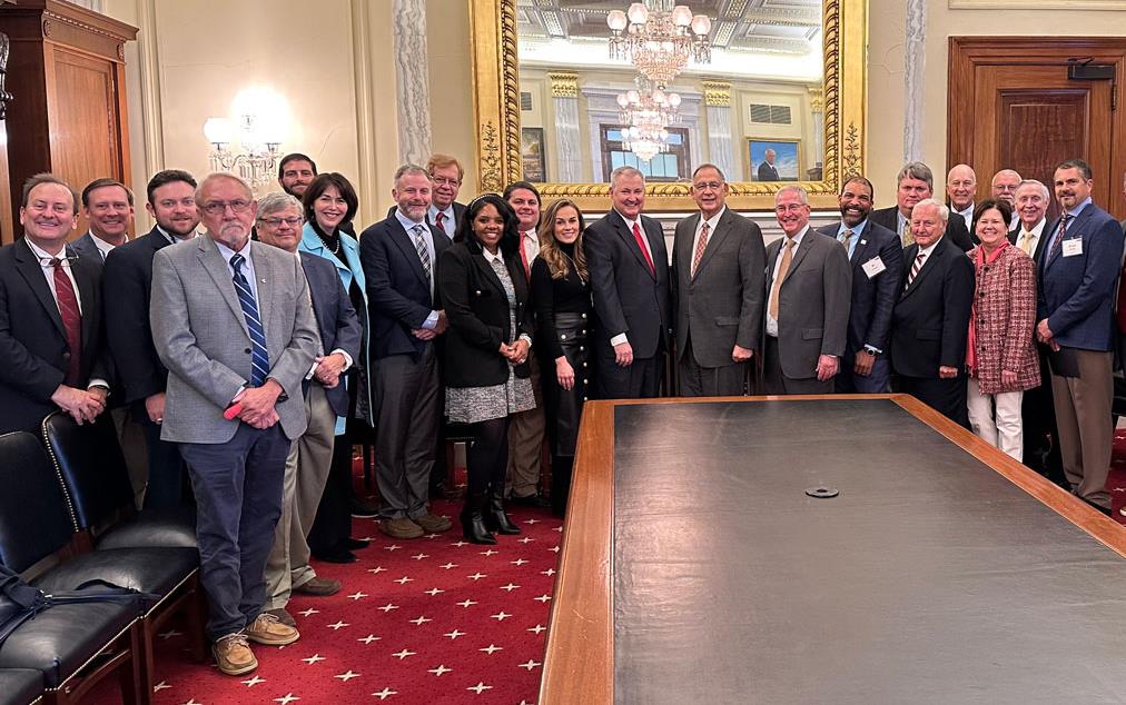 Group-shot-with-Senator-Boozman in ornate conference room on Capitol Hill