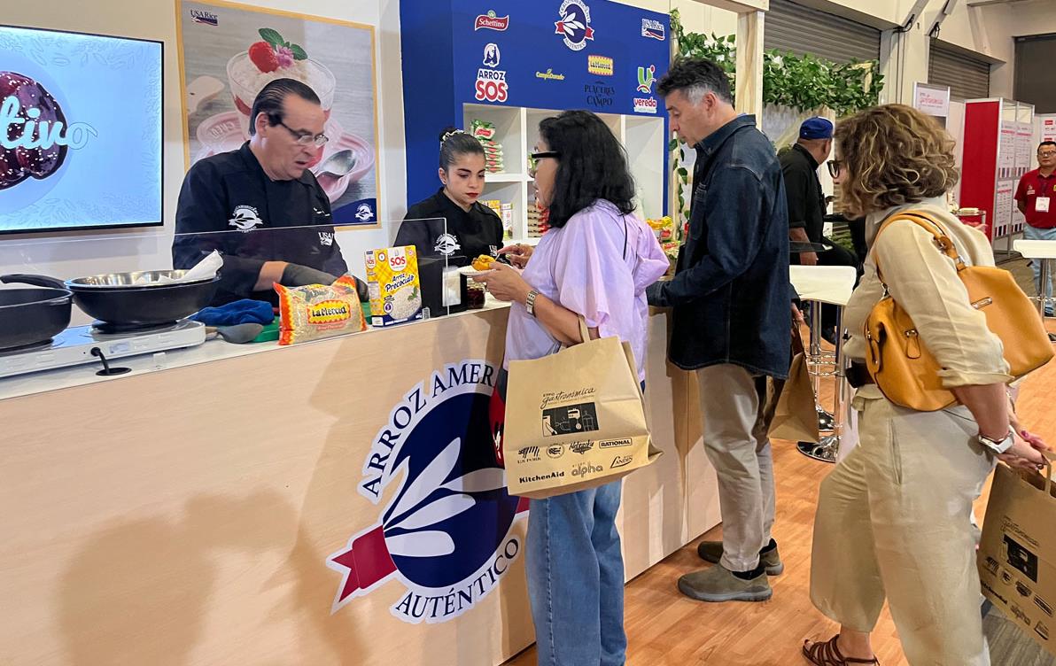 2023-Expo-Gastronomica,-people lined up at USAR-booth decorated w/branding and logos