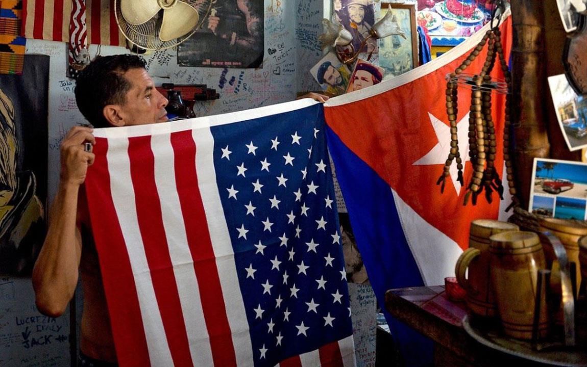 Man-holding-US-&-Cuban-flags