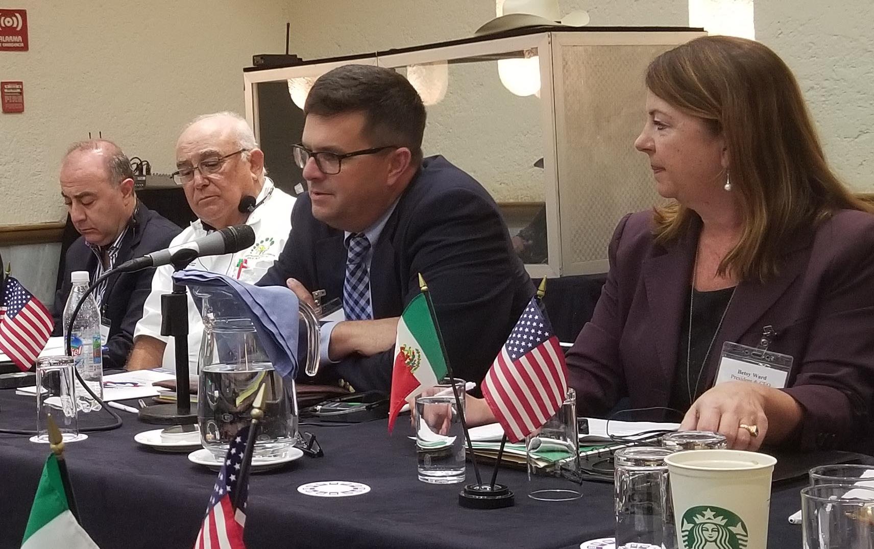  Trade Mission to Mexico, people sitting around board room table with small US & Mexican flags