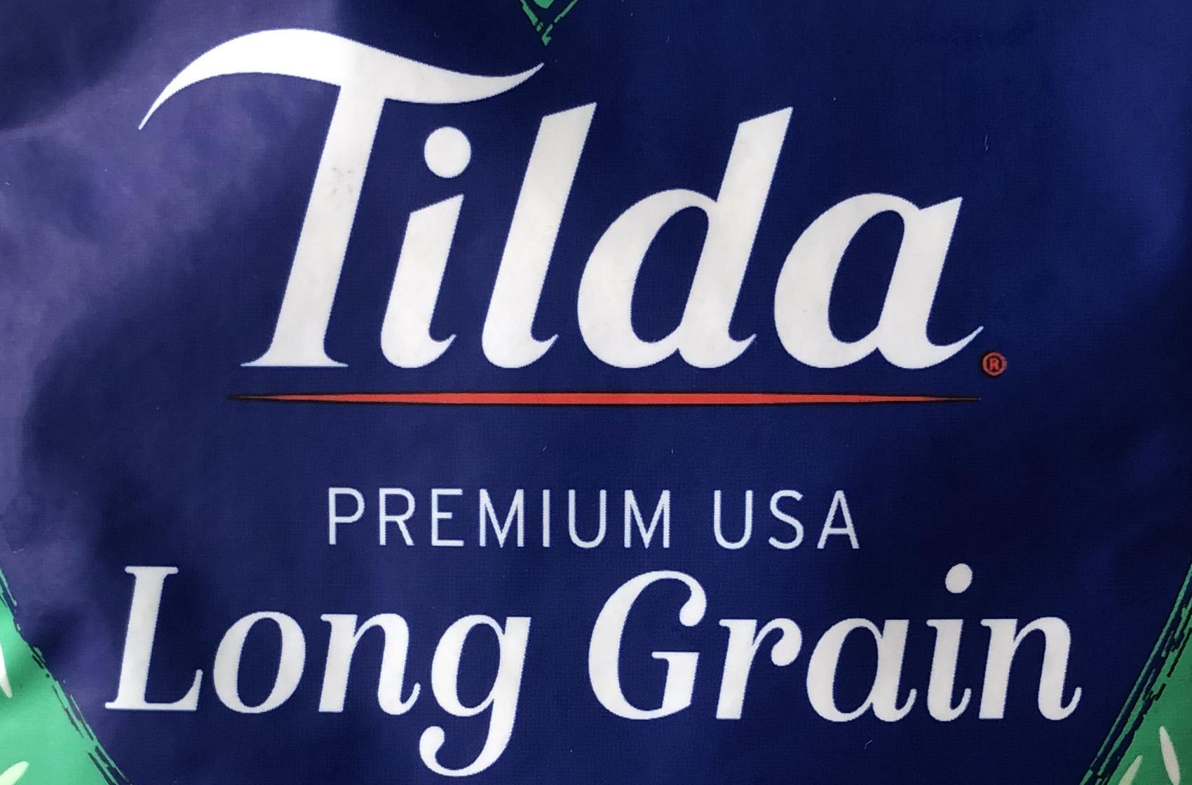 Green package with blue heart in the center with text "Tilda Long Grain Rice"