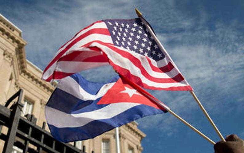 US & Cuban flags flying