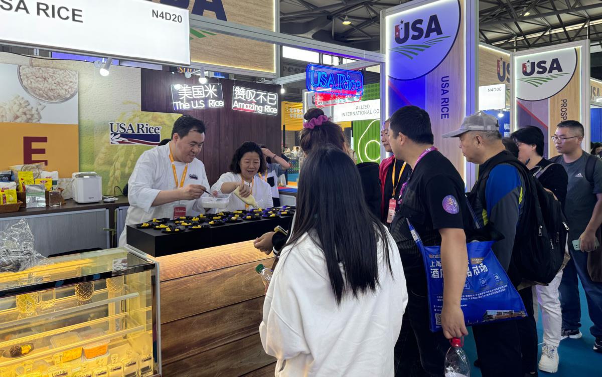 USA-Rice-Booth-at-China-Trade-Show, chefs prepare food samples for long line of people waiting for a taste