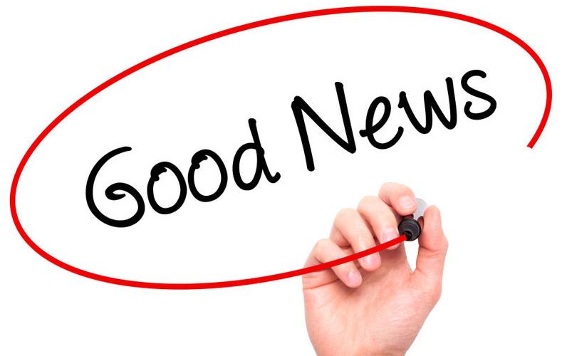 Hand holding pen writes "Good News" and draws red circle around words