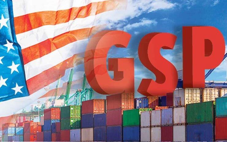 Shipping containers and American flag in background behind red capital letters G-S-P