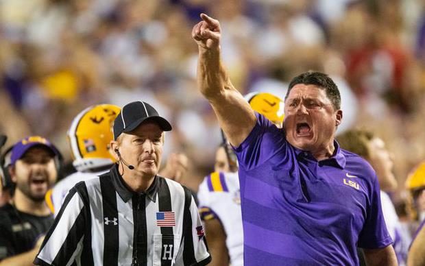 LSU Coach Ed Orgeron gets animated, referee stands nearby