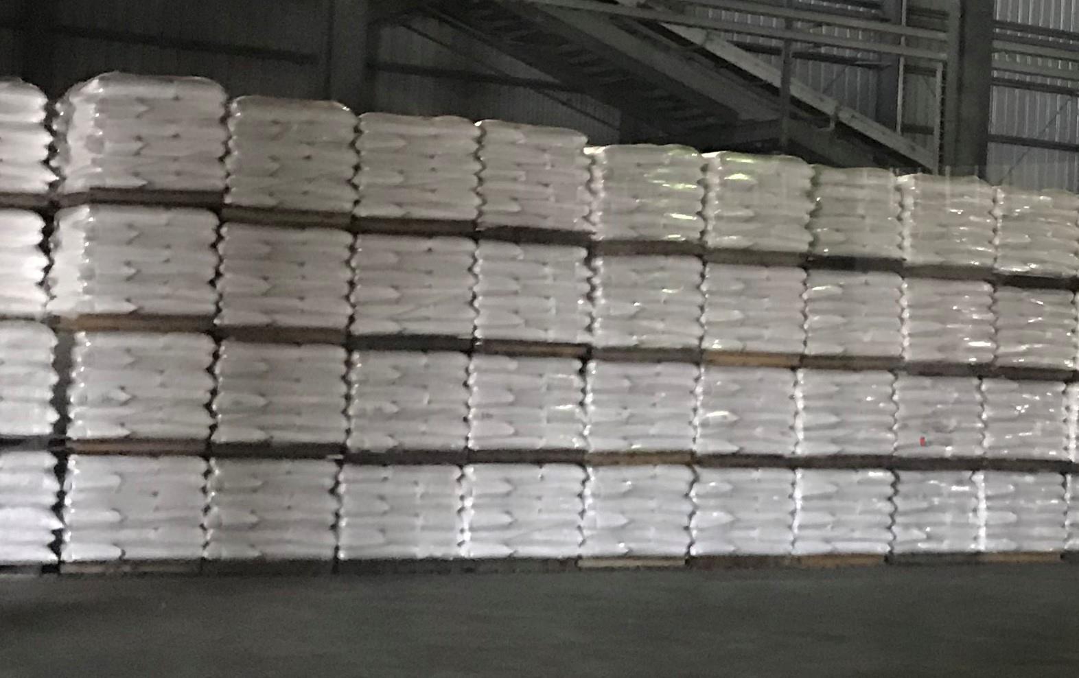 Warehouse full of bags of rice, stacked on pallets, ready to be shipped out