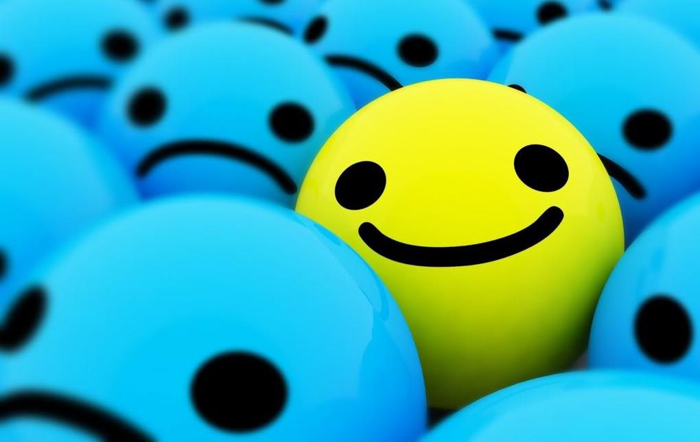 Yellow smiling circle in midst of crowd of blue frowning circles