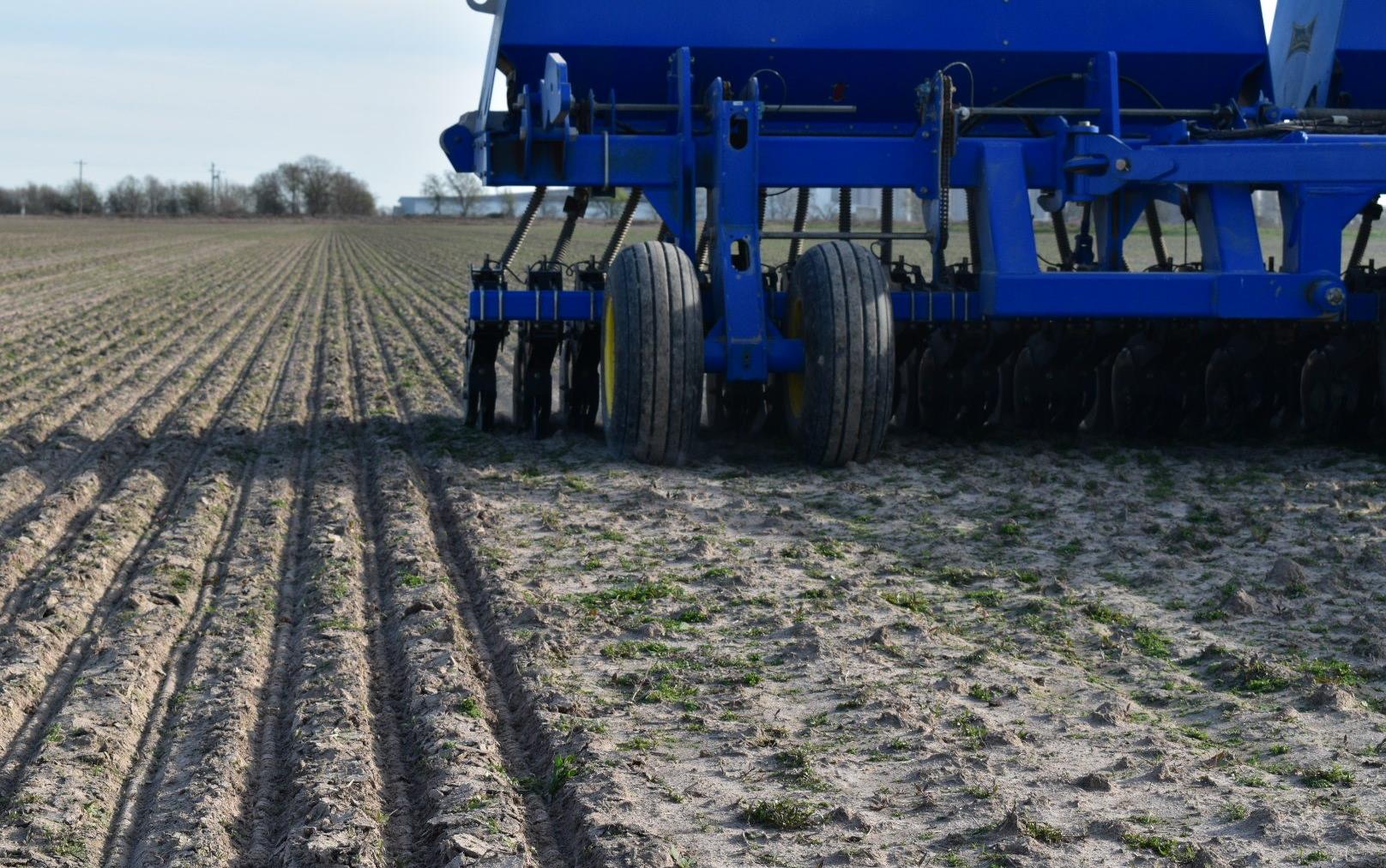 Blue combine creating furrows in new field