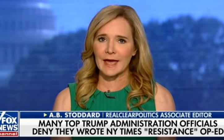 White woman with long, blonde hair speaks directly to camera, blue background