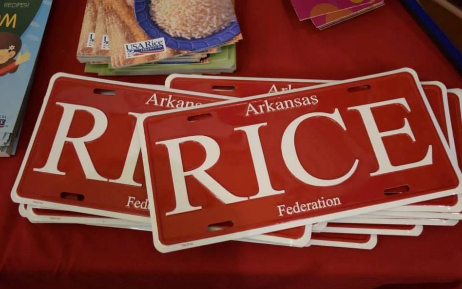 Stack of Arkansas Rice license plates on display table