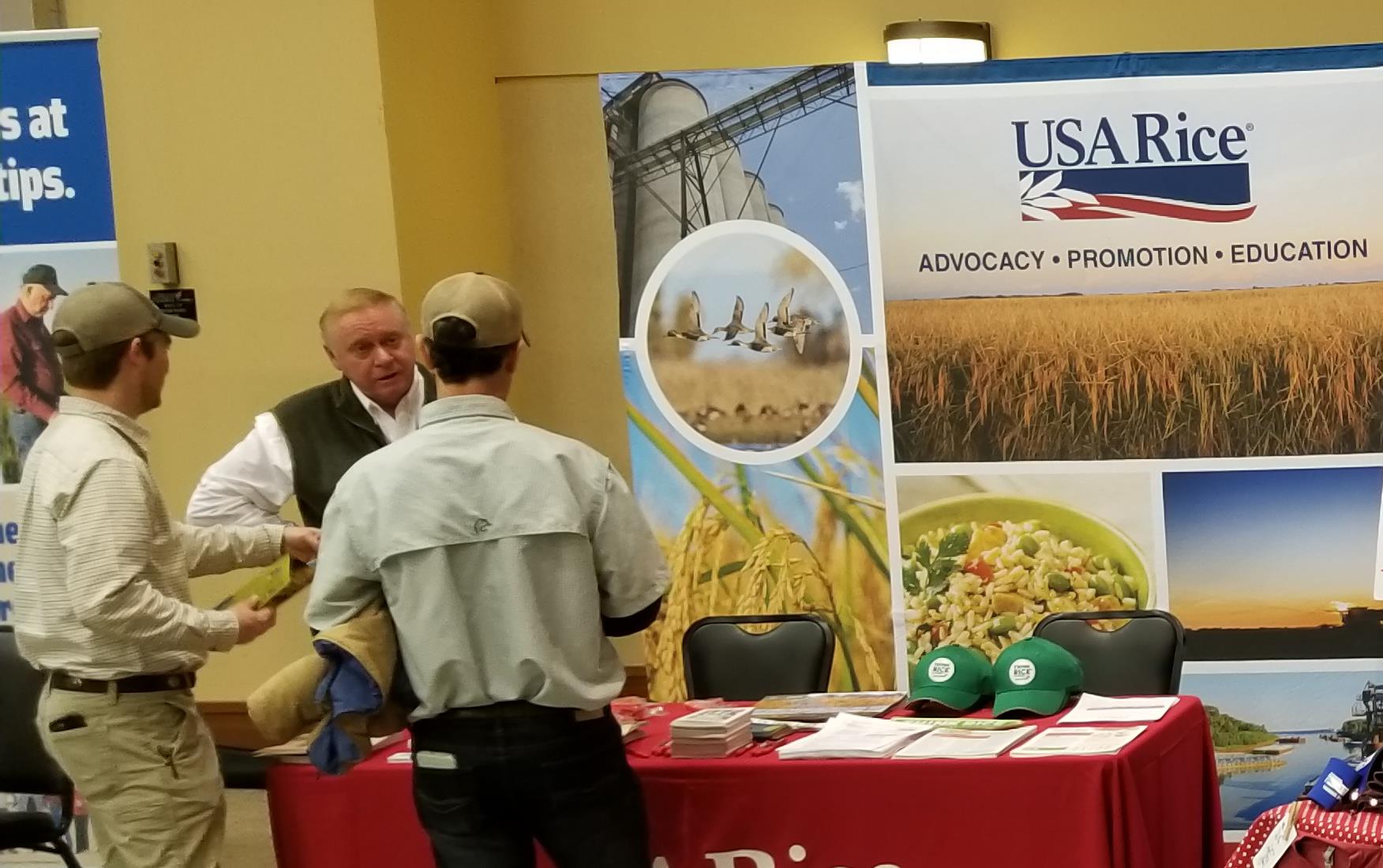 Booth adorned with rice messages, t-shirts, & posters at AR State meeting