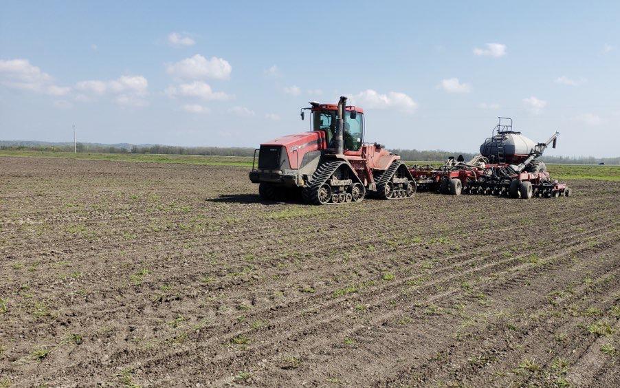 Red drill seeding equipment plants rice in new dirt field