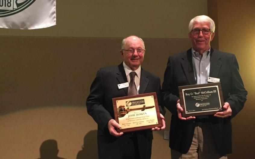 Producers Rice Mill 75th Anniversary, retirees hold plaques standing under anniversary banner