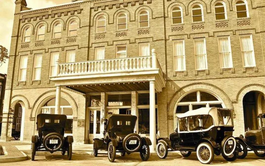 Vintage photo of Grand Opera House of the South with antique cars parked in front