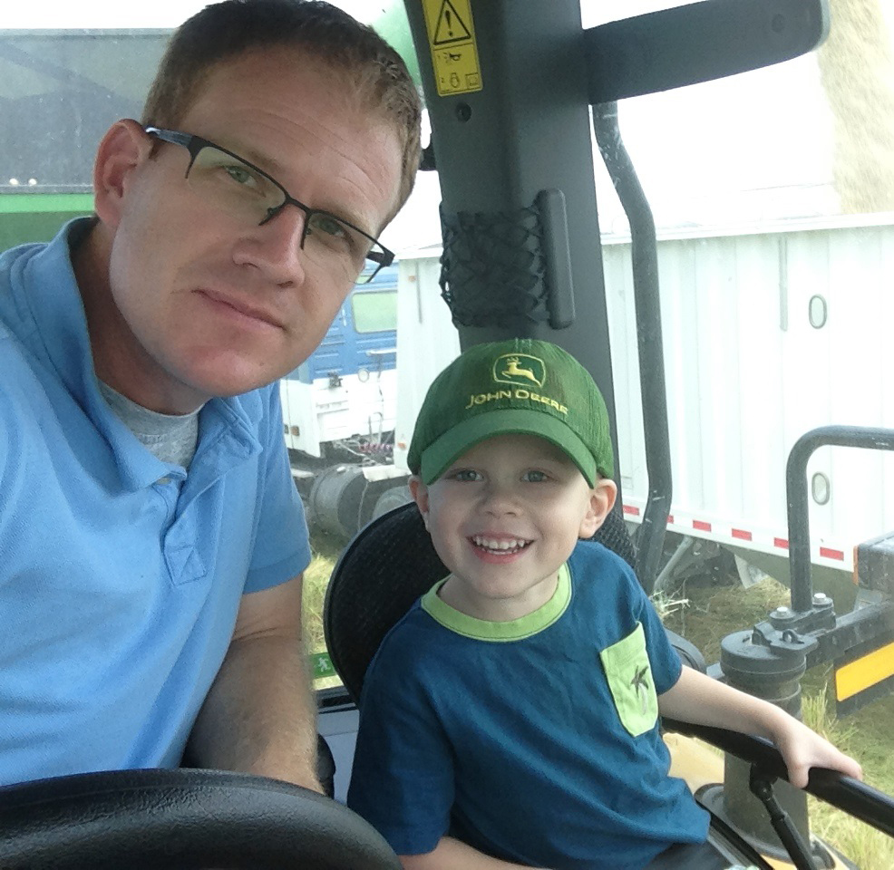 Mark Isbell and son, Sam, in a combine