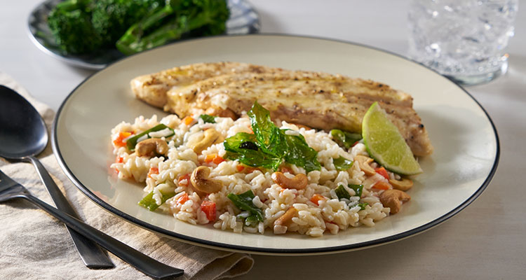 Miso Snapper Coconut Rice Pilaf Side view of Miso Snapper Coconut Rice Pilaf on a white plate.